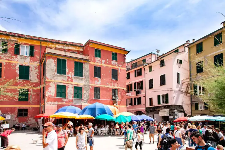 Vernazza's seafront square with café tables